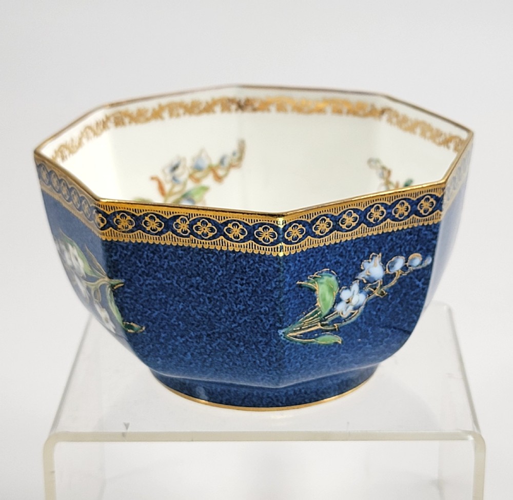 An octagonal Wedgwood lustre porcelain bowl featuring a blue mottled exterior adorned with hand-painted floral motifs and gilt borders. View II