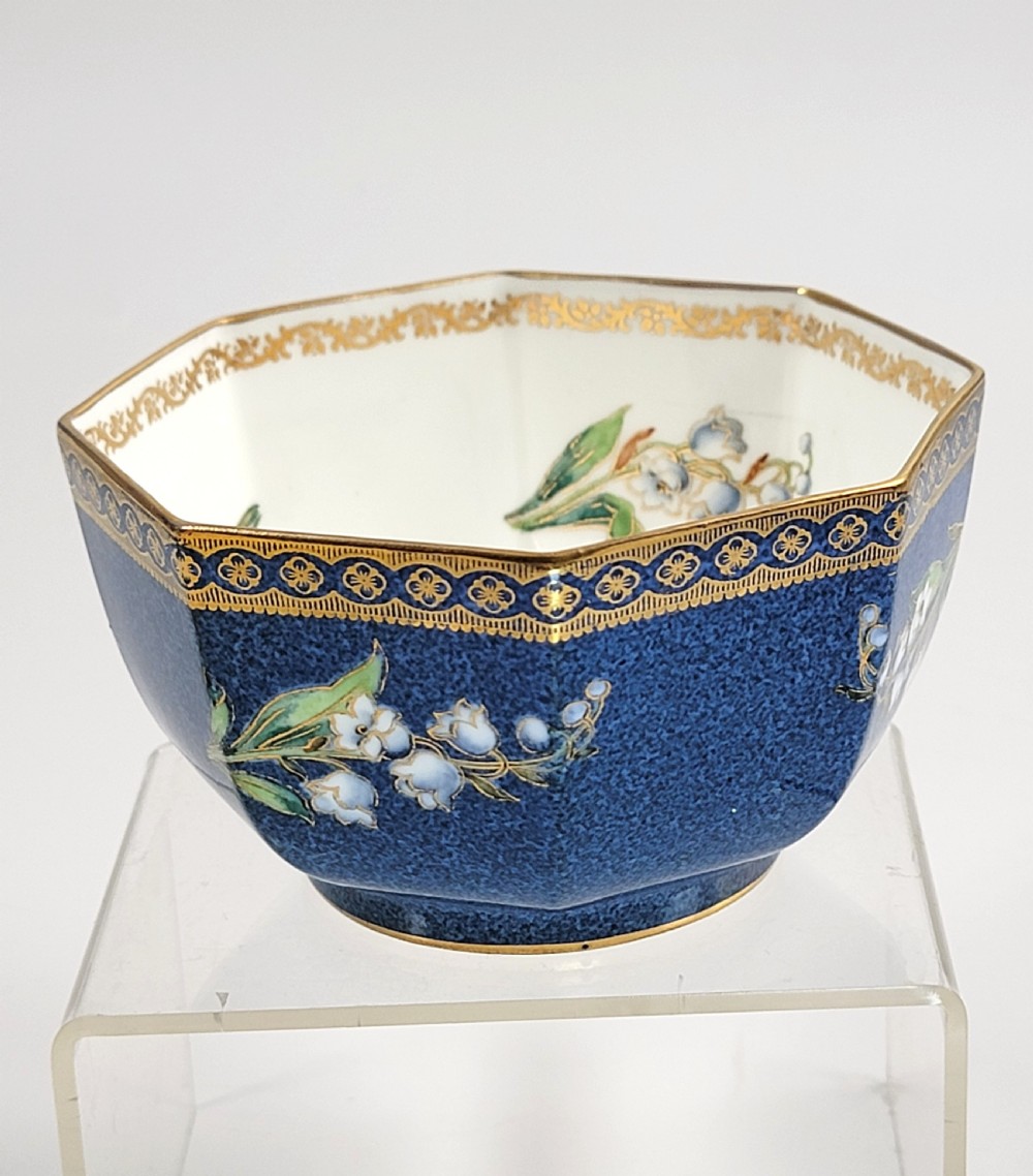 An octagonal Wedgwood lustre porcelain bowl featuring a blue mottled exterior adorned with hand-painted floral motifs and gilt borders. View V