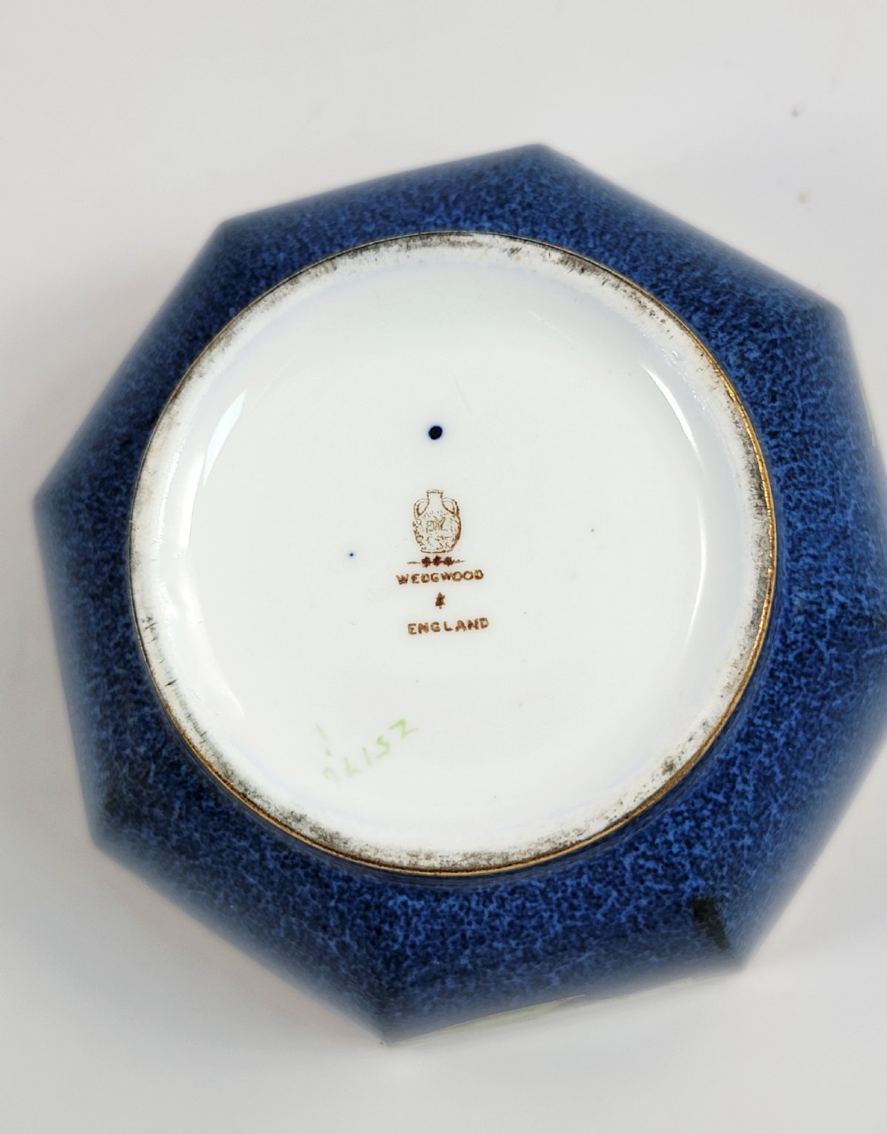 An octagonal Wedgwood lustre porcelain bowl featuring a blue mottled exterior adorned with hand-painted floral motifs and gilt borders. View VII