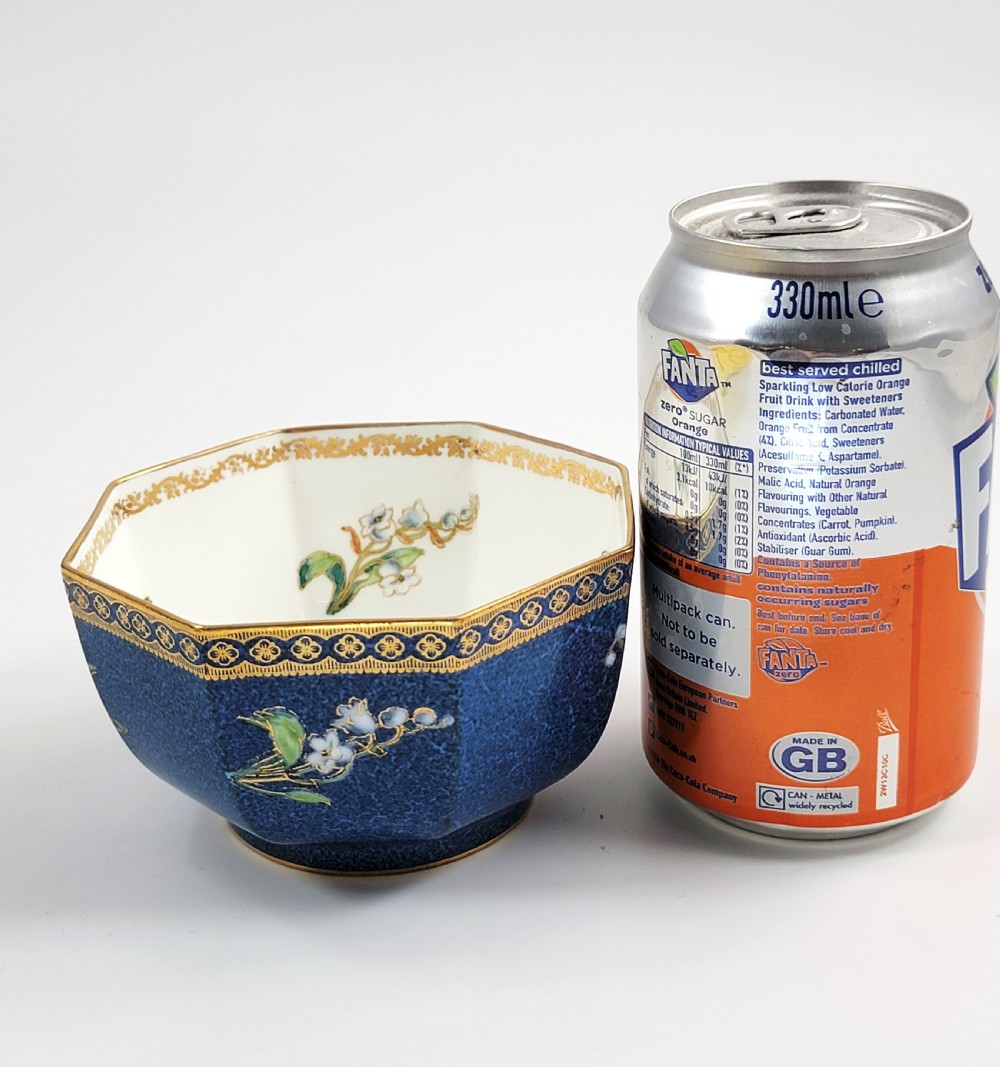 An octagonal Wedgwood lustre porcelain bowl featuring a blue mottled exterior adorned with hand-painted floral motifs and gilt borders. View VIII