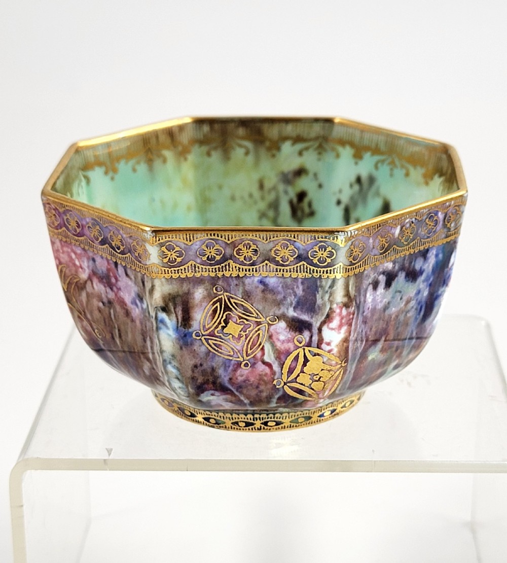 An octagonal antique Wedgwood lustre bowl featuring an iridescent purple exterior with gold gilded motifs and a pale green interior.