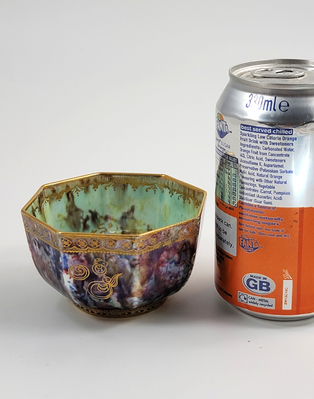 An octagonal antique Wedgwood lustre bowl featuring an iridescent purple exterior with gold gilded motifs and a pale green interior. View XI