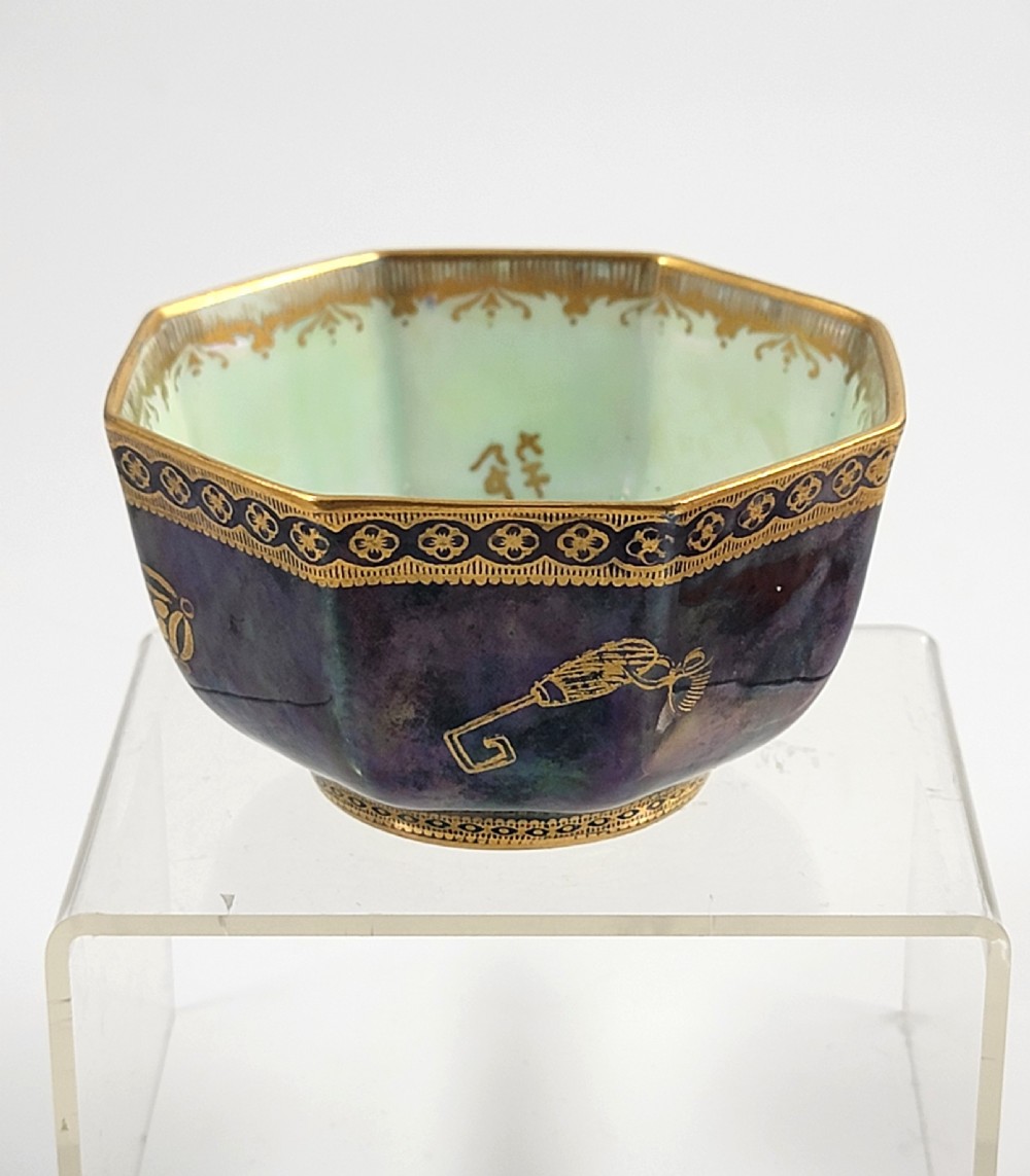 An octagonal porcelain bowl featuring a deep blue iridescent exterior with gilt line drawings and a pale green pearlescent interior. View III