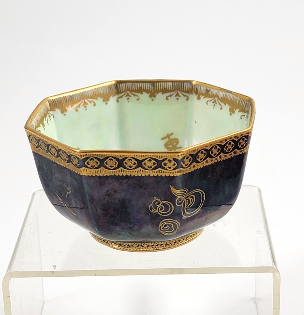 An octagonal porcelain bowl featuring a deep blue iridescent exterior with gilt line drawings and a pale green pearlescent interior. View IV