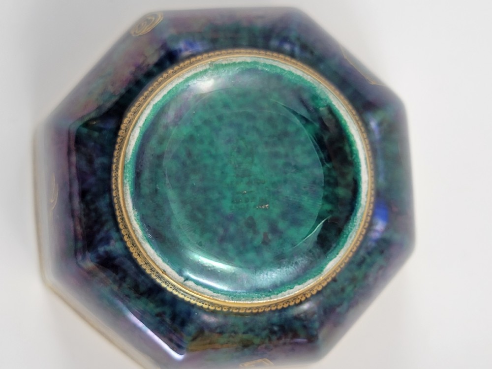 An octagonal porcelain bowl featuring a deep blue iridescent exterior with gilt line drawings and a pale green pearlescent interior. View VII