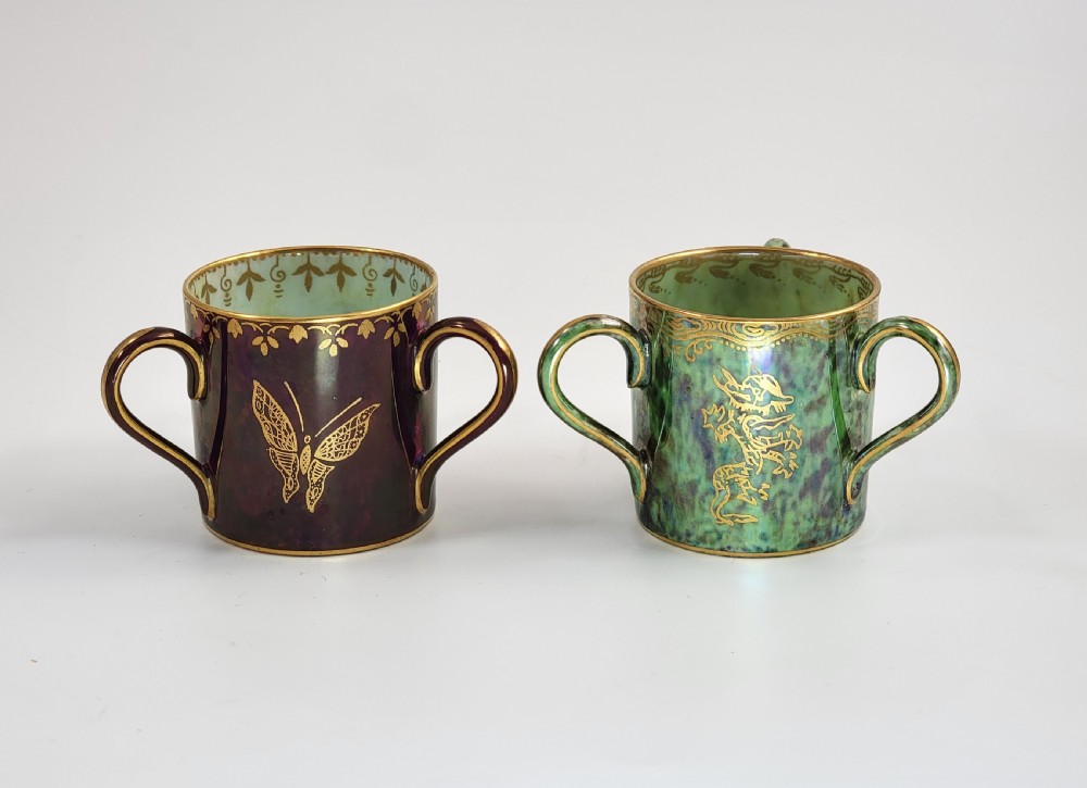 A pair of small three-handled ceramic cups, one in deep purple with a gilded butterfly design and the other in iridescent green with a gilded snake motif. View III