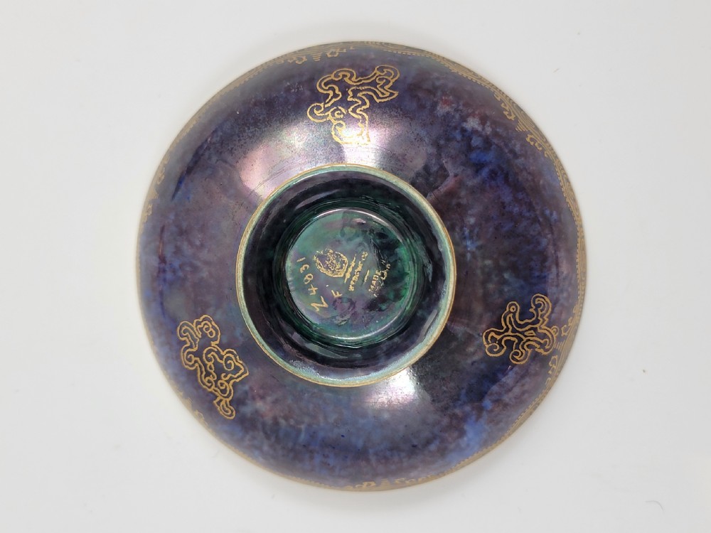 A set of three miniature footed porcelain bowls featuring iridescent lustre glazes in shades of blue, orange, and turquoise, embellished with gilded rim details and central motifs. View VI