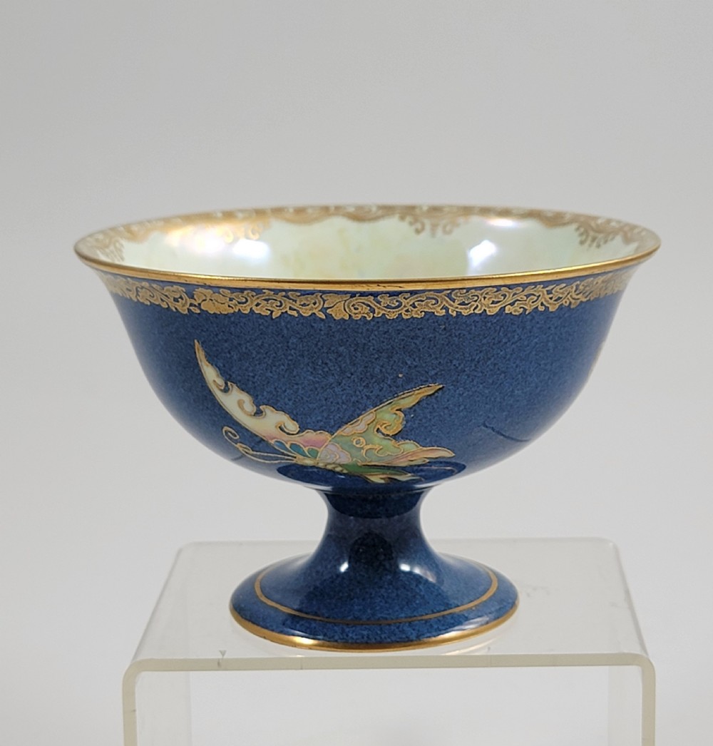 A footed Wedgwood porcelain bowl featuring a deep blue mottled exterior embellished with a gilded butterfly and an iridescent pearlescent interior with gold trim. View III