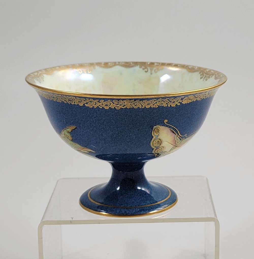 A footed Wedgwood porcelain bowl featuring a deep blue mottled exterior embellished with a gilded butterfly and an iridescent pearlescent interior with gold trim. View IV