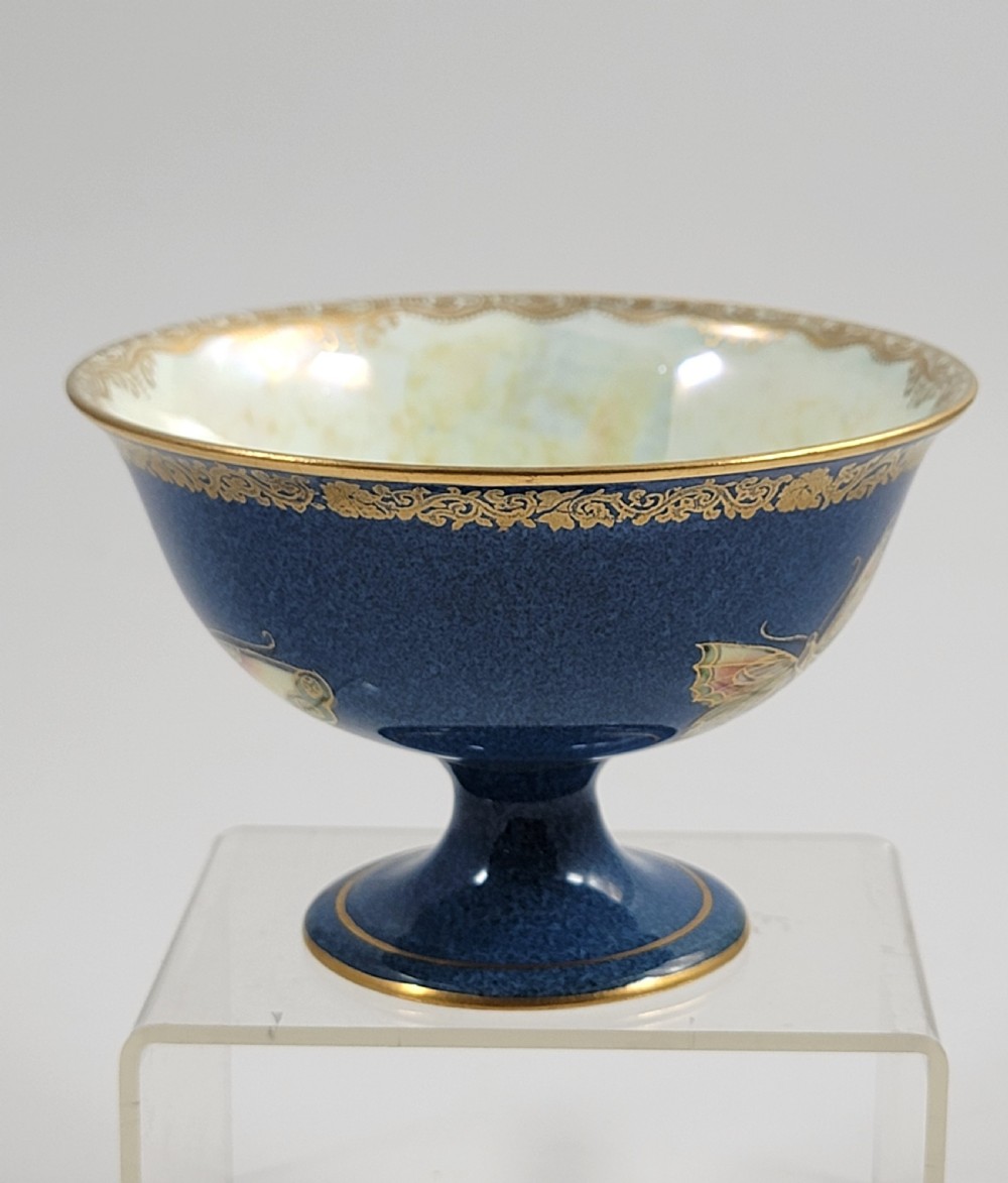 A footed Wedgwood porcelain bowl featuring a deep blue mottled exterior embellished with a gilded butterfly and an iridescent pearlescent interior with gold trim. View VI