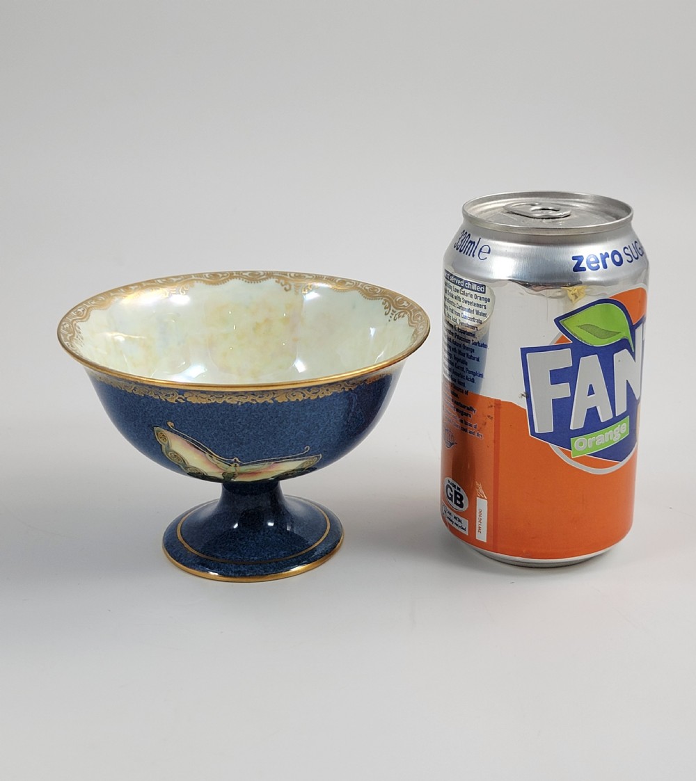 A footed Wedgwood porcelain bowl featuring a deep blue mottled exterior embellished with a gilded butterfly and an iridescent pearlescent interior with gold trim. View XI