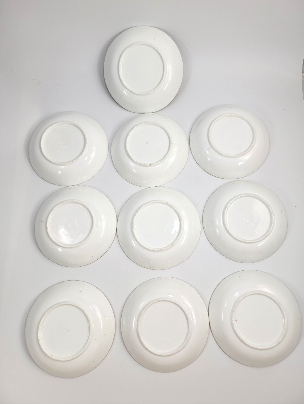 A Victorian Minton porcelain tea set featuring cups, stacked saucers, and a milk jug adorned with polychrome Kakiemon style tigers, bamboo, and flora. View XVI