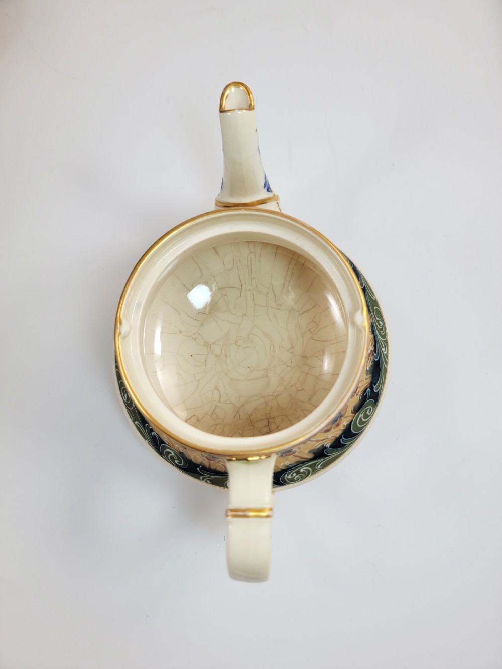 An antique four-piece Art Nouveau ceramic tea service decorated with tube-lined ochre poppy motifs and dark green glaze borders with gilded accents. View XI