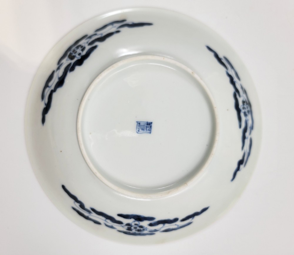A near-pair of circular white Japanese porcelain plates decorated with hand-painted cobalt blue depictions of two koi fish. View VIII
