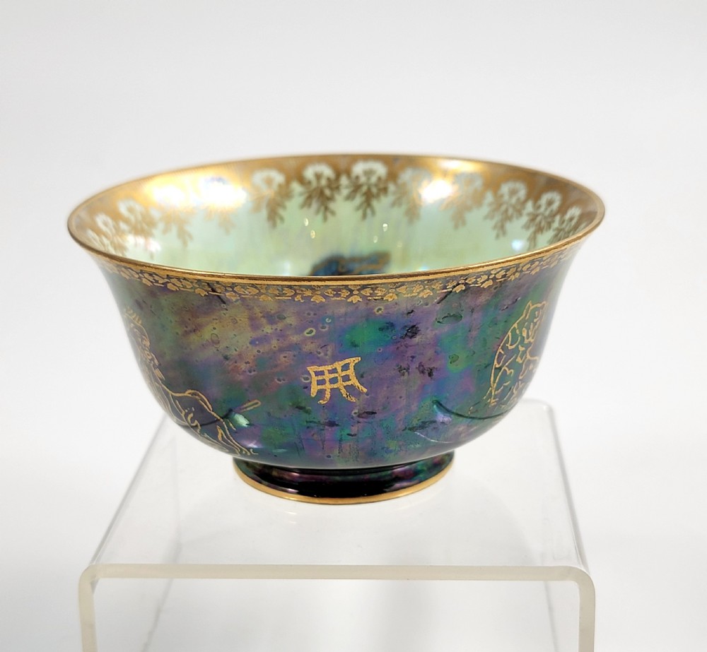 An antique footed porcelain bowl featuring iridescent purple and green glazes decorated with gilt dragons and ornamental borders. View II