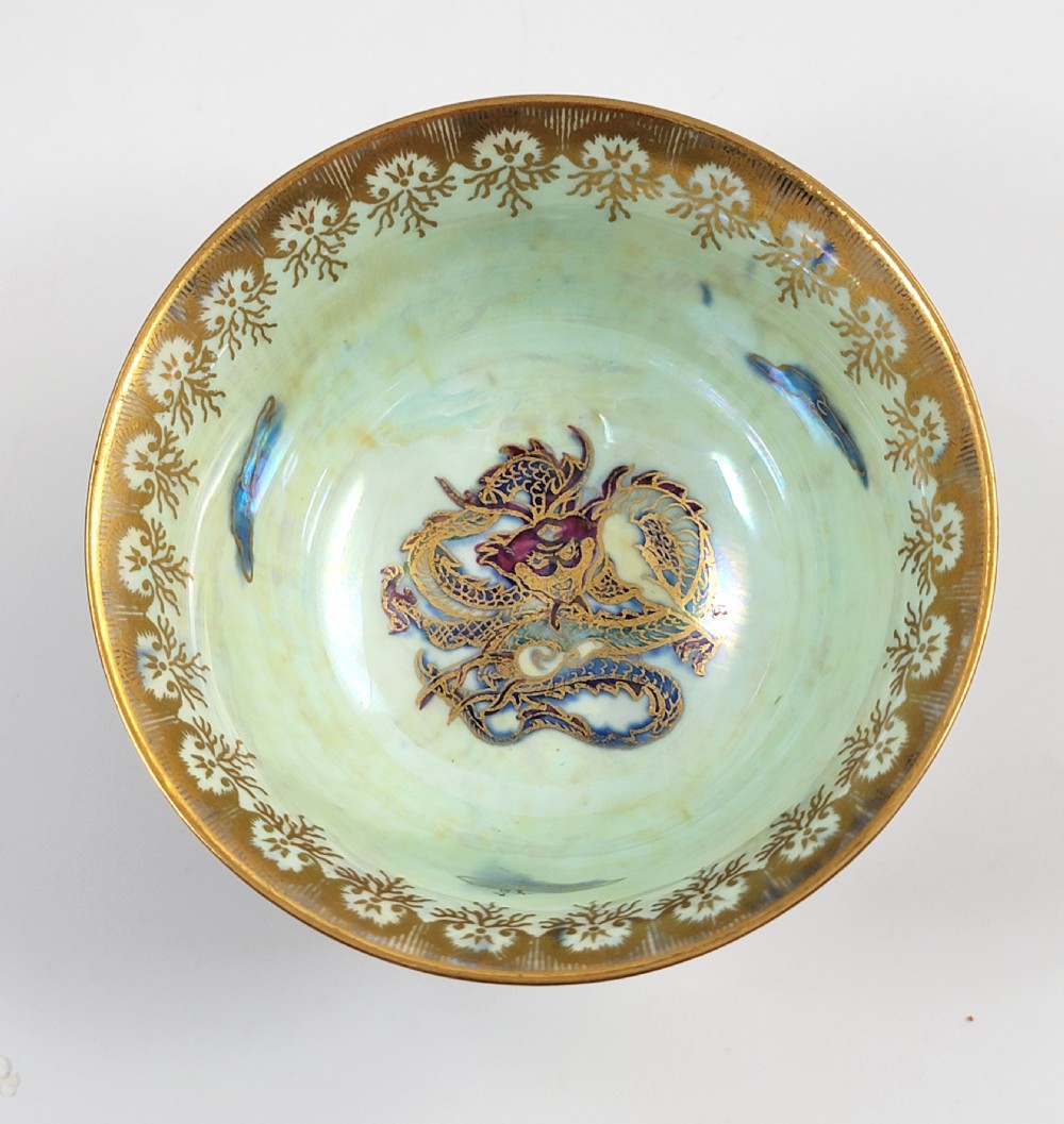An antique footed porcelain bowl featuring iridescent purple and green glazes decorated with gilt dragons and ornamental borders. View VII