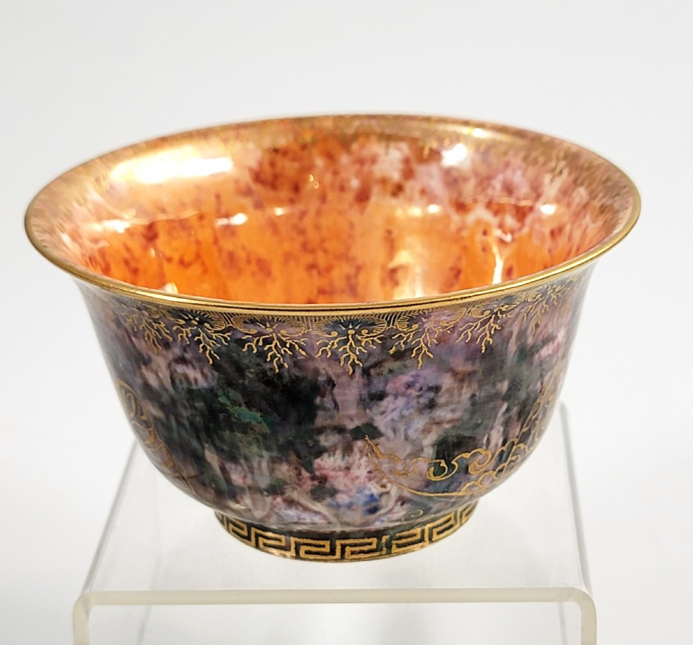 A circular porcelain bowl featuring a mottled iridescent purple exterior decorated with gilt butterfly motifs and a gold-toned orange interior. View III