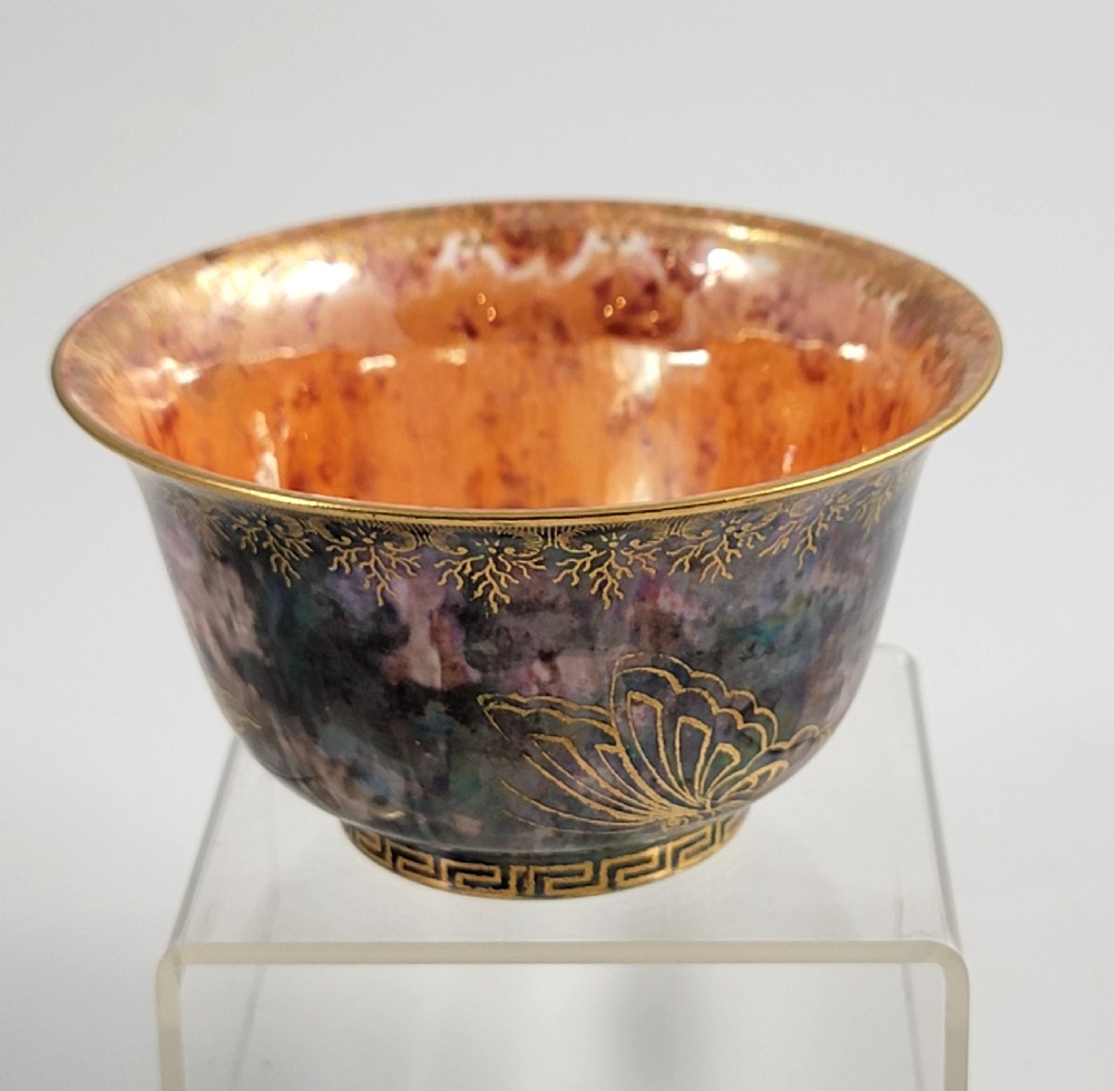 A circular porcelain bowl featuring a mottled iridescent purple exterior decorated with gilt butterfly motifs and a gold-toned orange interior. View IV