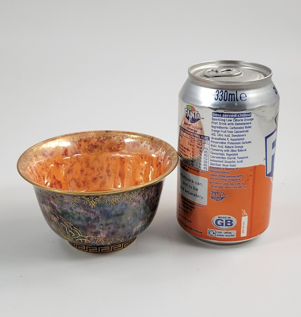 A circular porcelain bowl featuring a mottled iridescent purple exterior decorated with gilt butterfly motifs and a gold-toned orange interior. View VIII