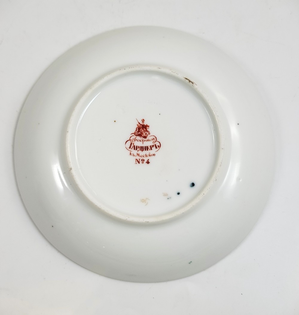 An antique cobalt blue porcelain teacup and matching saucer featuring hand-painted floral medallions and gold rim trim. View III