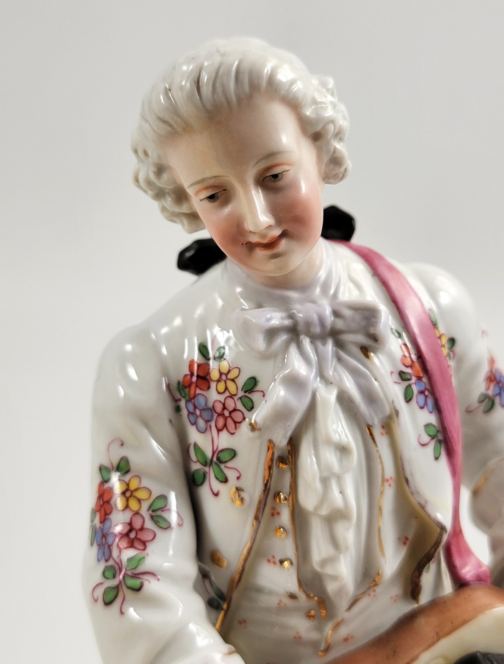 A Samson of Paris porcelain figure depicting an eighteenth-century male musician holding a hurdy-gurdy, decorated with hand-painted floral motifs and gilding. View XI
