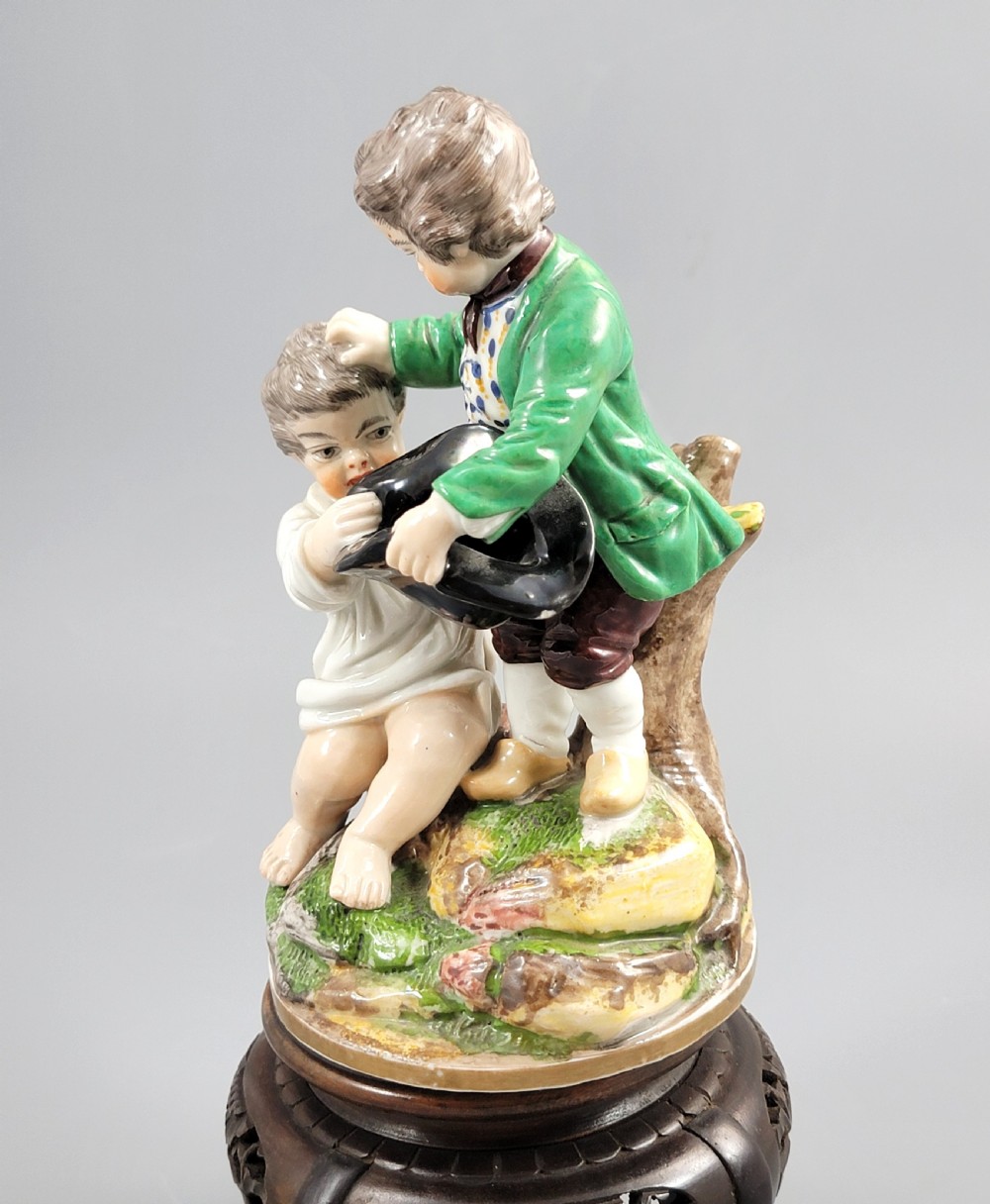 A French Niderviller porcelain figure group depicting two young boys on a rocky naturalistic base. View IV