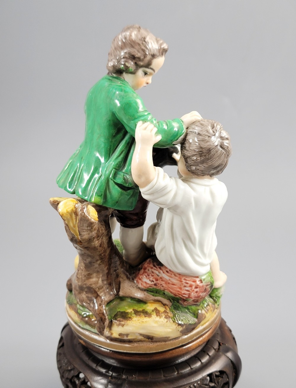 A French Niderviller porcelain figure group depicting two young boys on a rocky naturalistic base. View VII