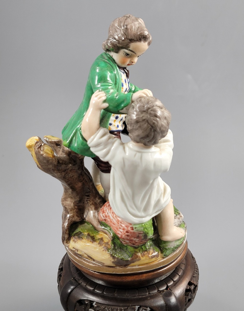 A French Niderviller porcelain figure group depicting two young boys on a rocky naturalistic base. View VIII