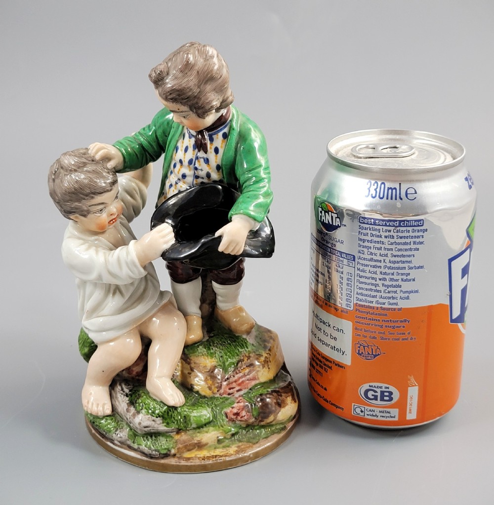 A French Niderviller porcelain figure group depicting two young boys on a rocky naturalistic base. View XII