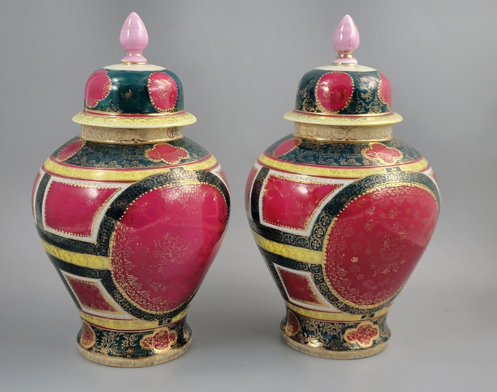 A pair of nineteenth-century Royal Vienna style porcelain covered urns featuring hand-painted classical figures inside oval gilt reserves, set against teal, pink, and yellow enamelled grounds. View III