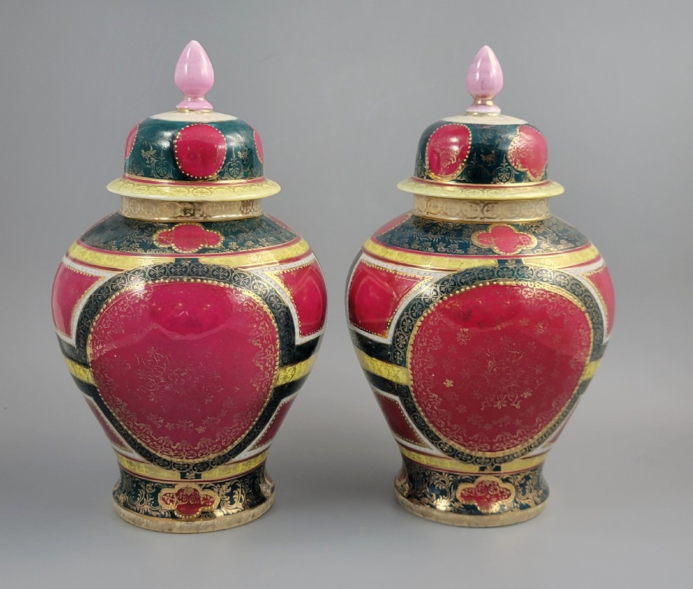 A pair of nineteenth-century Royal Vienna style porcelain covered urns featuring hand-painted classical figures inside oval gilt reserves, set against teal, pink, and yellow enamelled grounds. View IV