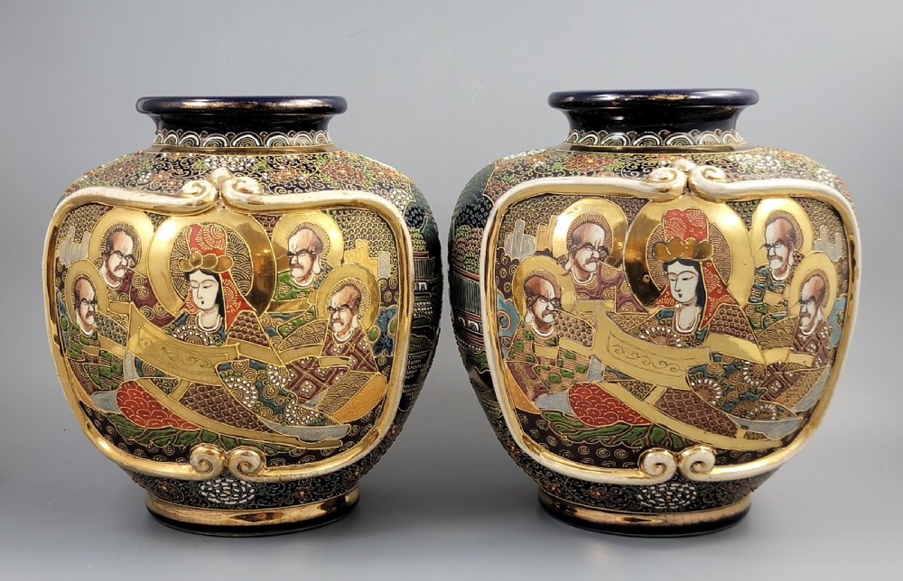A pair of bulbous Japanese Satsuma earthenware vases decorated with raised moriage enamel and gilding depicting Buddhist figures.
