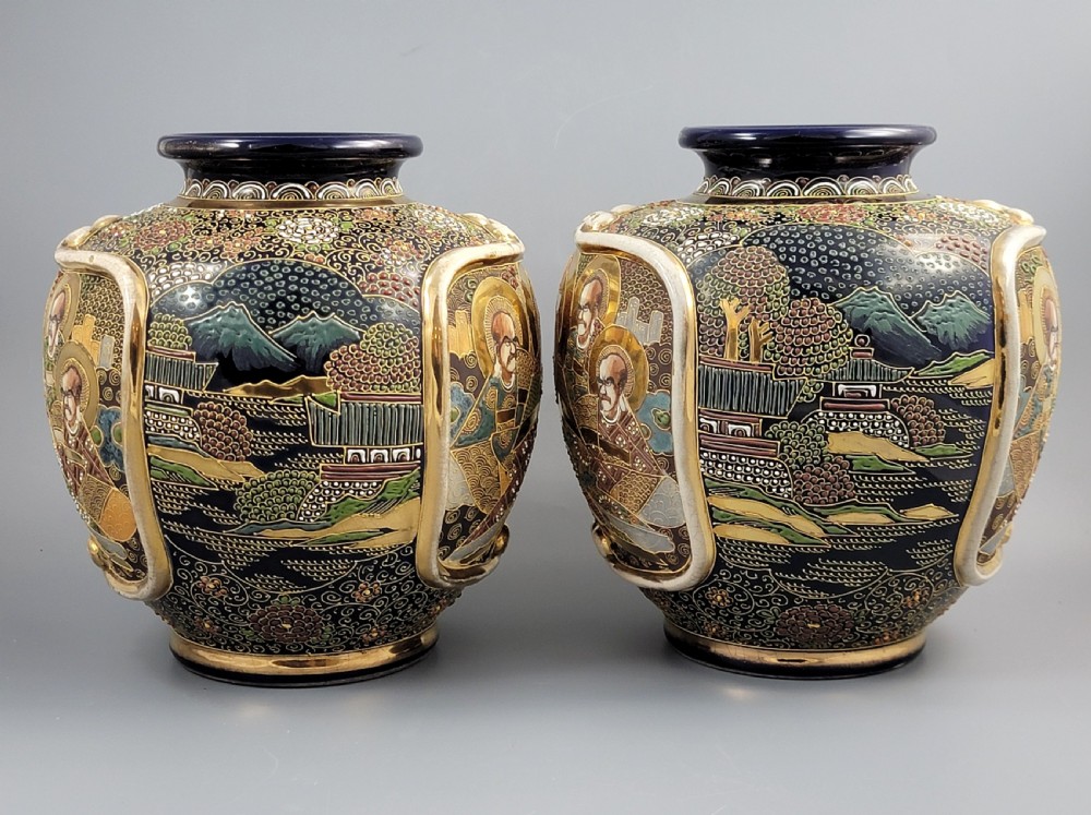 A pair of bulbous Japanese Satsuma earthenware vases decorated with raised moriage enamel and gilding depicting Buddhist figures. View II