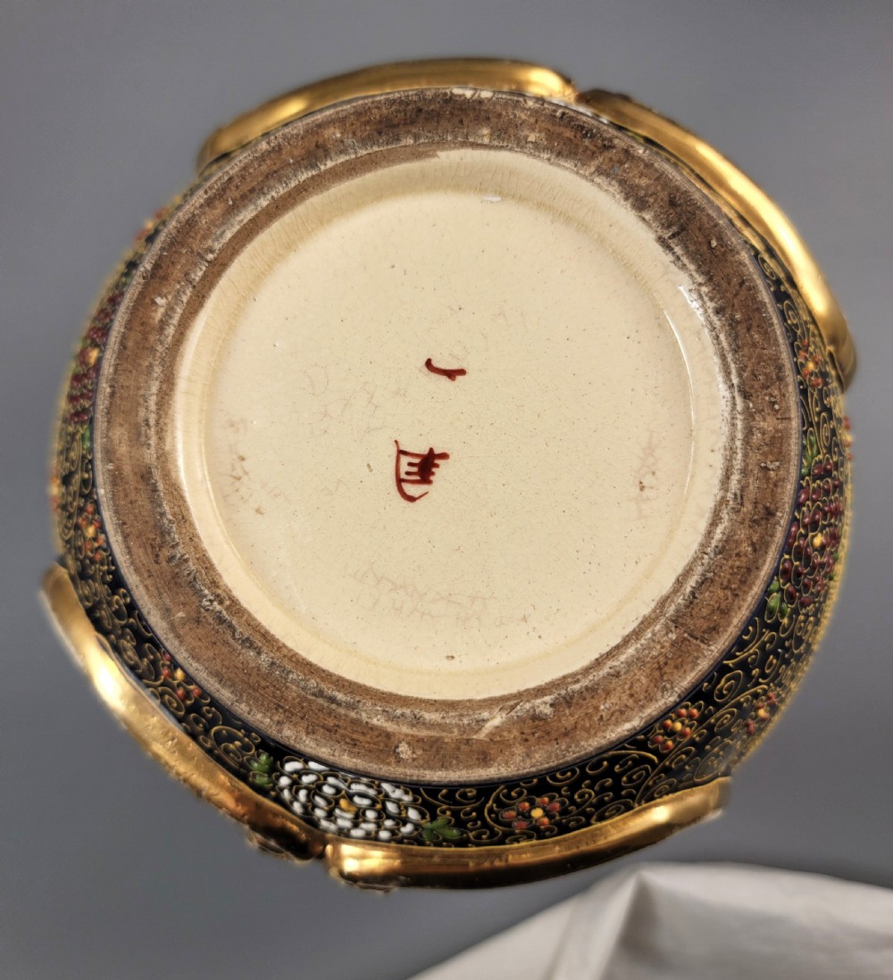A pair of bulbous Japanese Satsuma earthenware vases decorated with raised moriage enamel and gilding depicting Buddhist figures. View VI