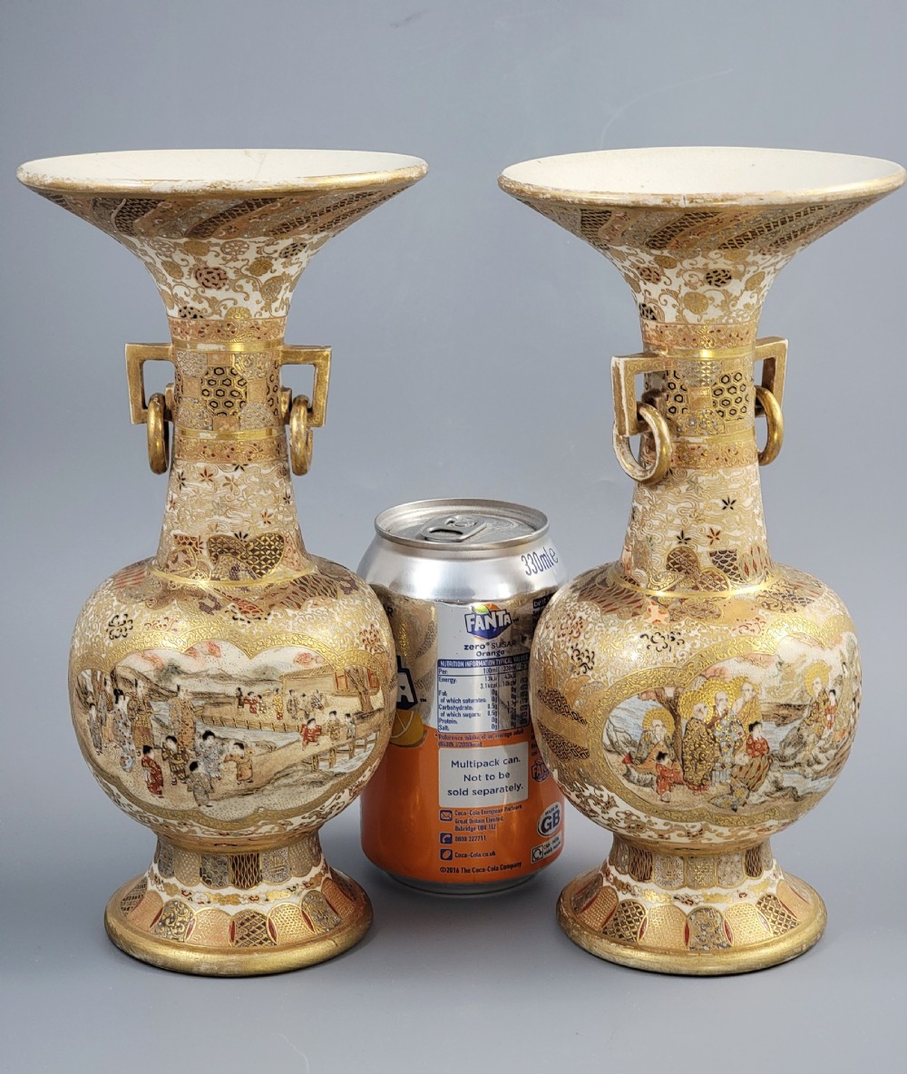 A pair of Japanese Satsuma earthenware vases featuring flared rims, fixed ring handles, and detailed hand-painted figural panels with extensive gold gilding. View XXIII