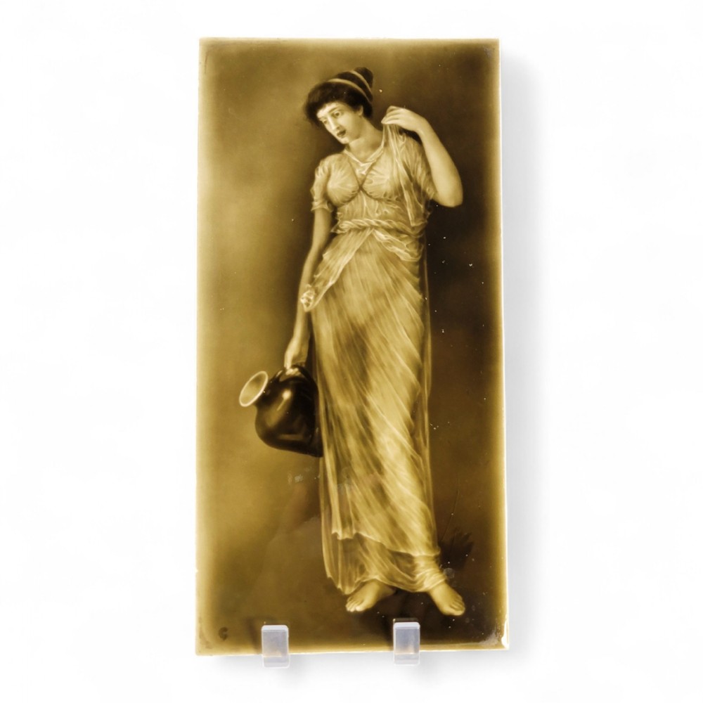 A rectangular Victorian ceramic tile featuring a sepia-toned relief portrait of a classically draped woman holding a water ewer.
