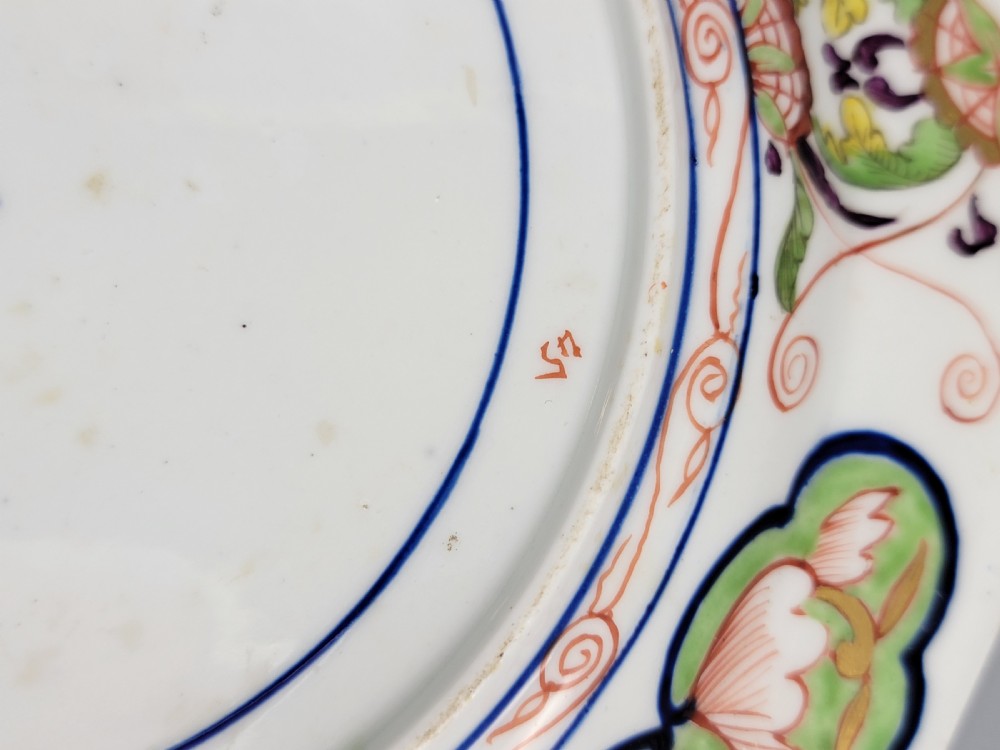A pair of circular late 18th-century Derby porcelain plates featuring scalloped rims and hand-painted polychrome Kylin pattern designs in orange, cobalt blue, pink, and green. View XI