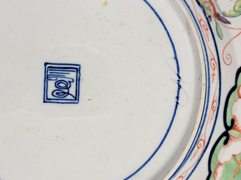 A pair of circular late 18th-century Derby porcelain plates featuring scalloped rims and hand-painted polychrome Kylin pattern designs in orange, cobalt blue, pink, and green. View XV