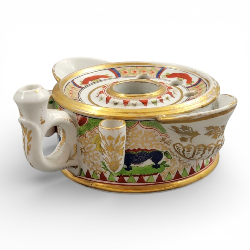 A circular Flight Barr and Barr Worcester porcelain inkwell decorated with the hand-painted Dragon in Compartments pattern, gold leaf borders, and built-in pen holders.