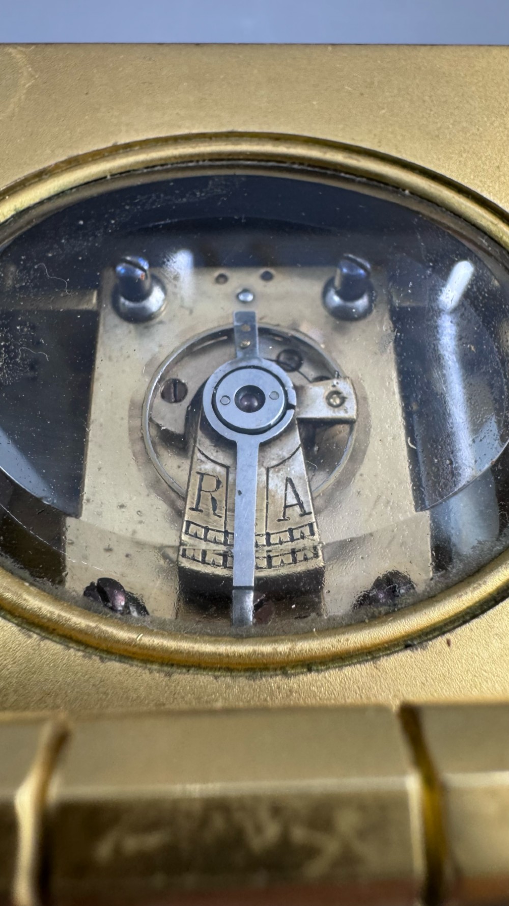 A late 19th-century French brass carriage clock housed inside a protective, textured brown leather travelling case with a leather carrying strap. View VI