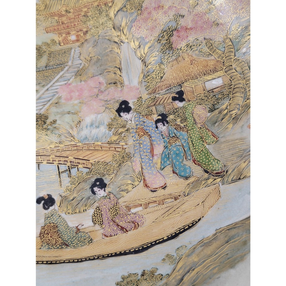 A Japanese Satsuma earthenware bowl with hand-painted figures under trees and gold accents, resting on a dark carved wooden stand. View III