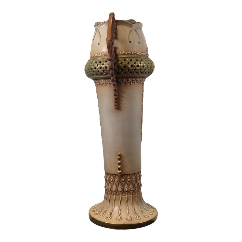 A tall Art Nouveau ceramic vase featuring a cream glaze body, brown reticulated handles, geometric relief beadwork, and a flared pedestal base. View II