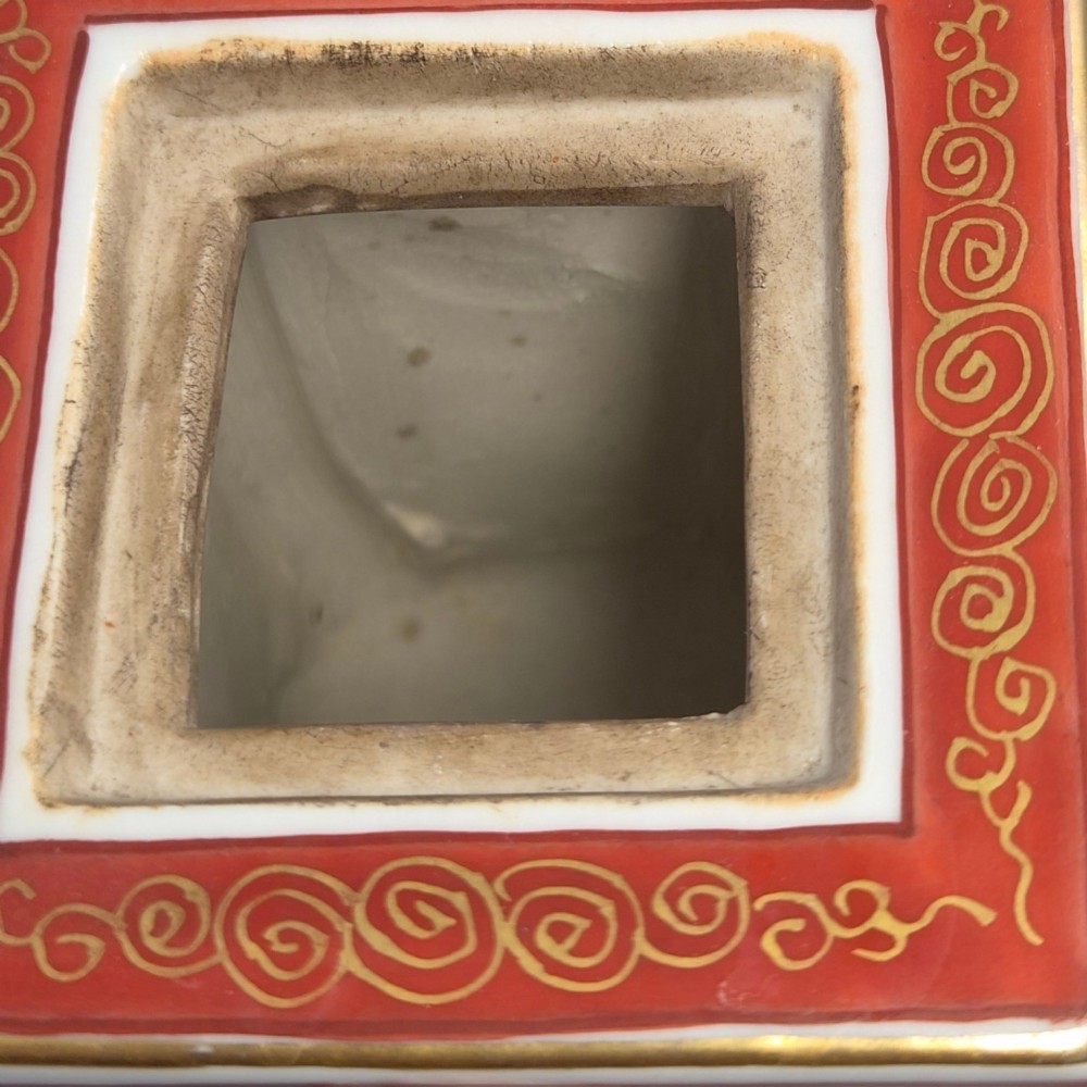 A rectangular Japanese porcelain incense burner featuring hand-painted depictions of a European ship, decorative red enamel borders, animal head handles, and a shishi lion finial on the lid. View IX