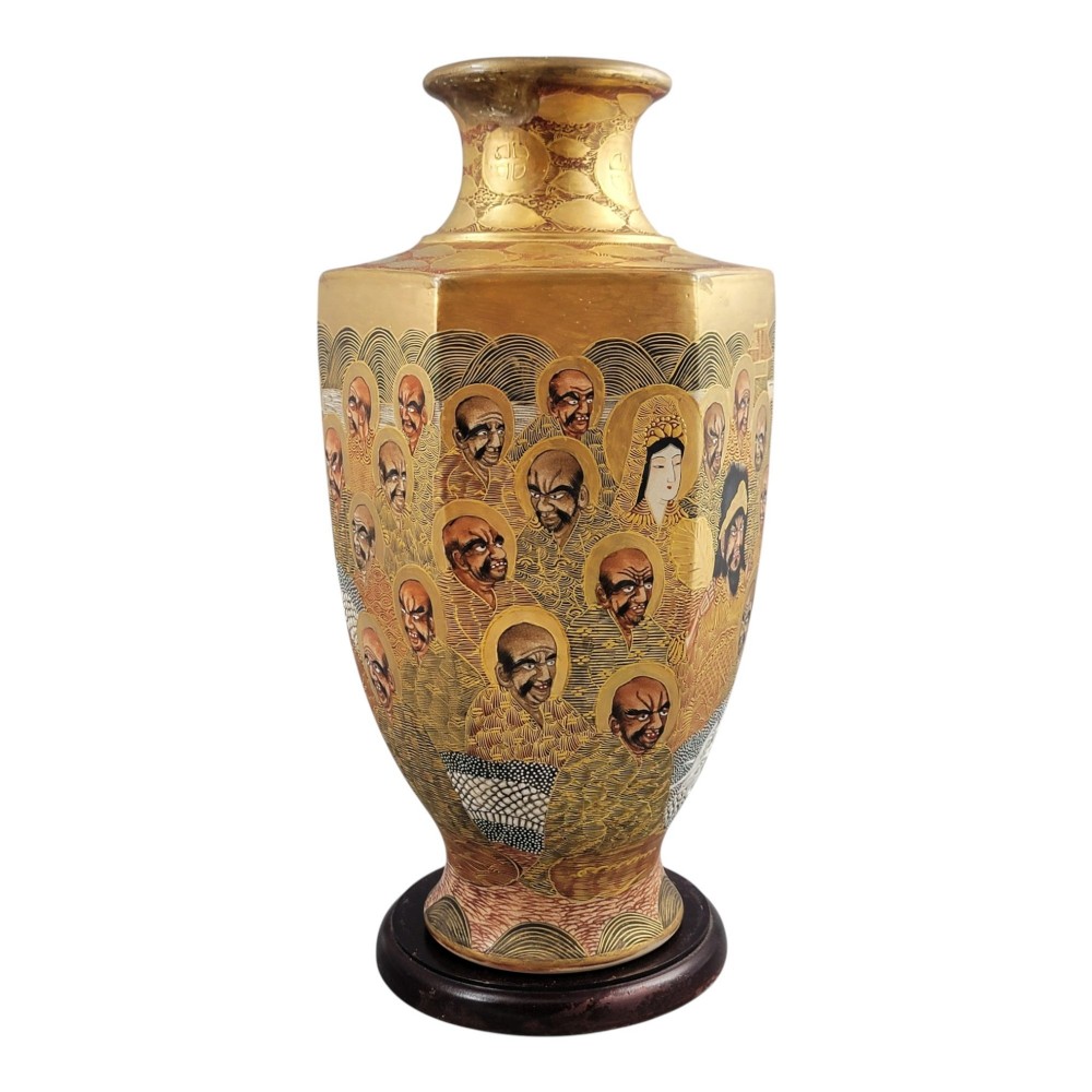 A tall gilded Japanese Satsuma earthenware vase painted with figures of Arhats and a dragon, set on a dark wooden base. View VI