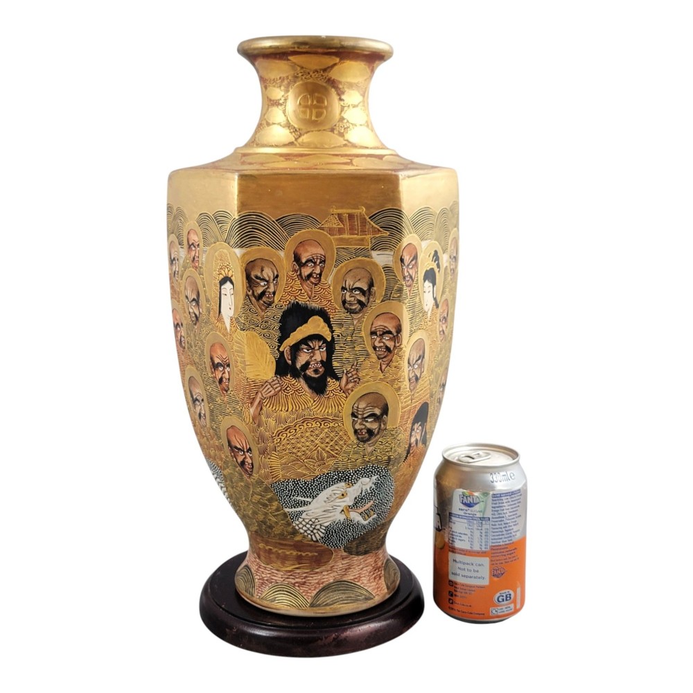 A tall gilded Japanese Satsuma earthenware vase painted with figures of Arhats and a dragon, set on a dark wooden base. View VII