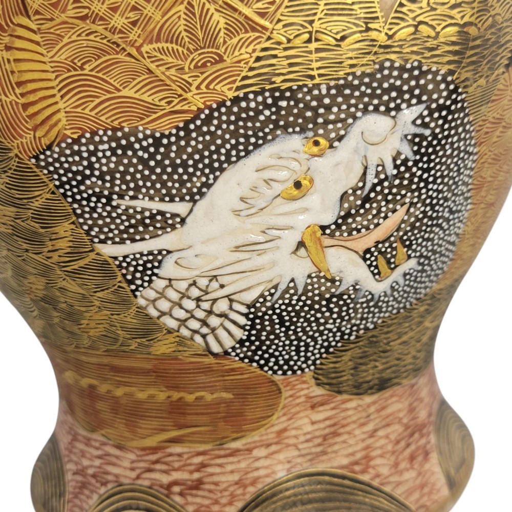 A tall gilded Japanese Satsuma earthenware vase painted with figures of Arhats and a dragon, set on a dark wooden base. View XII