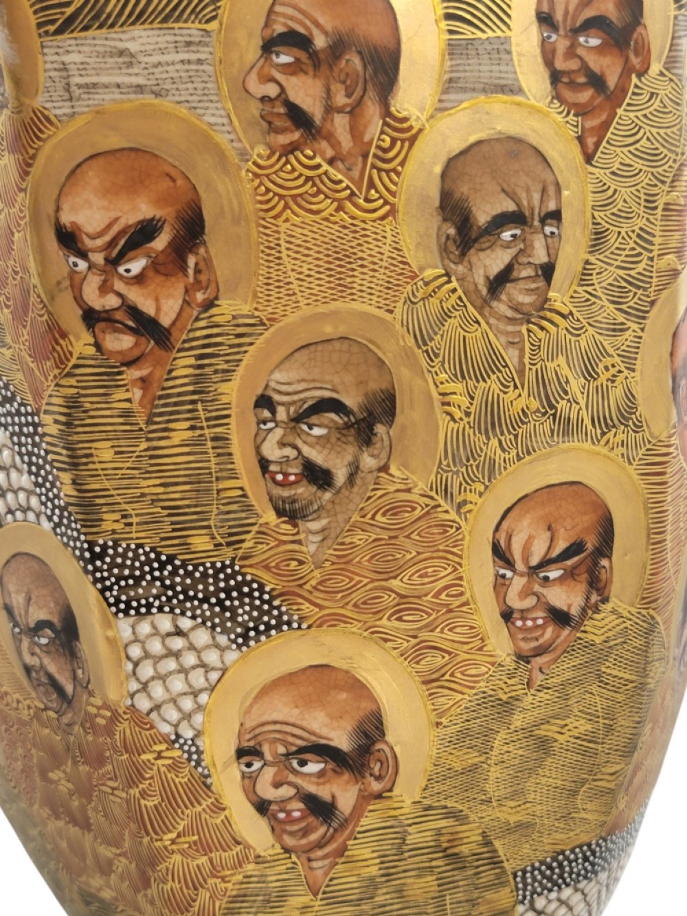 A tall gilded Japanese Satsuma earthenware vase painted with figures of Arhats and a dragon, set on a dark wooden base. View XIII