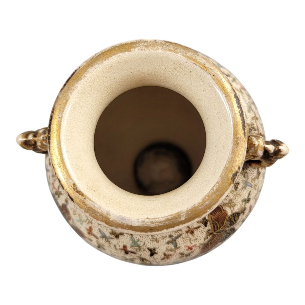 A pair of baluster-shaped Japanese Satsuma earthenware vases decorated with a dense pattern of polychrome butterflies and gold lion-dog side handles. View IV