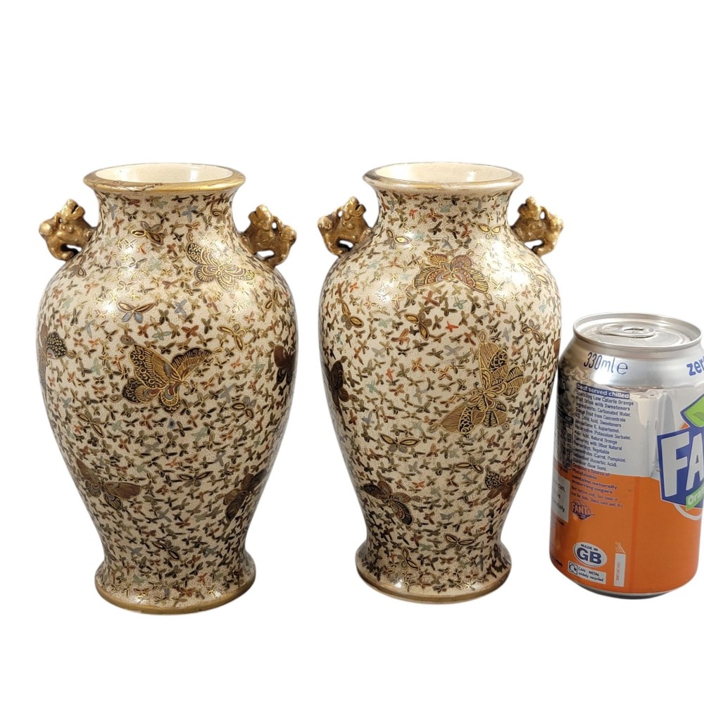 A pair of baluster-shaped Japanese Satsuma earthenware vases decorated with a dense pattern of polychrome butterflies and gold lion-dog side handles. View IX