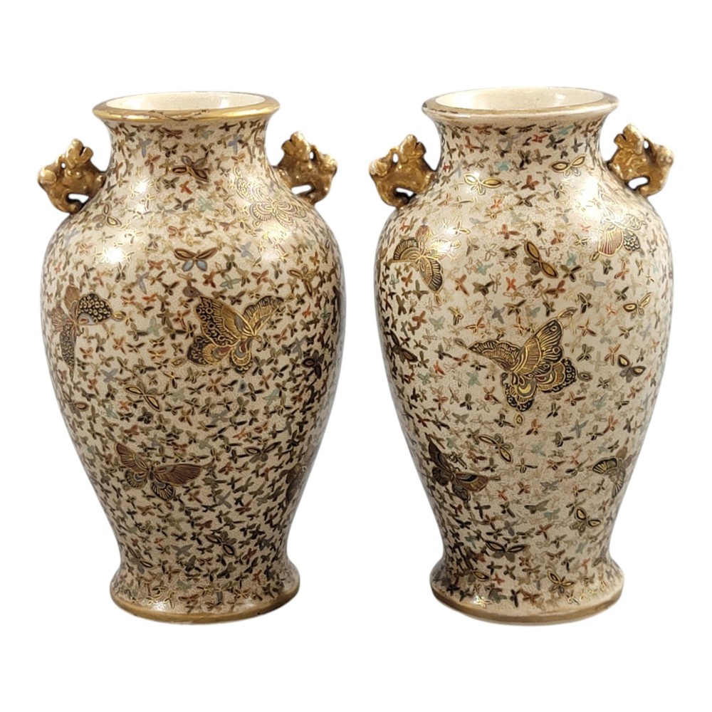 A pair of baluster-shaped Japanese Satsuma earthenware vases decorated with a dense pattern of polychrome butterflies and gold lion-dog side handles. View XI